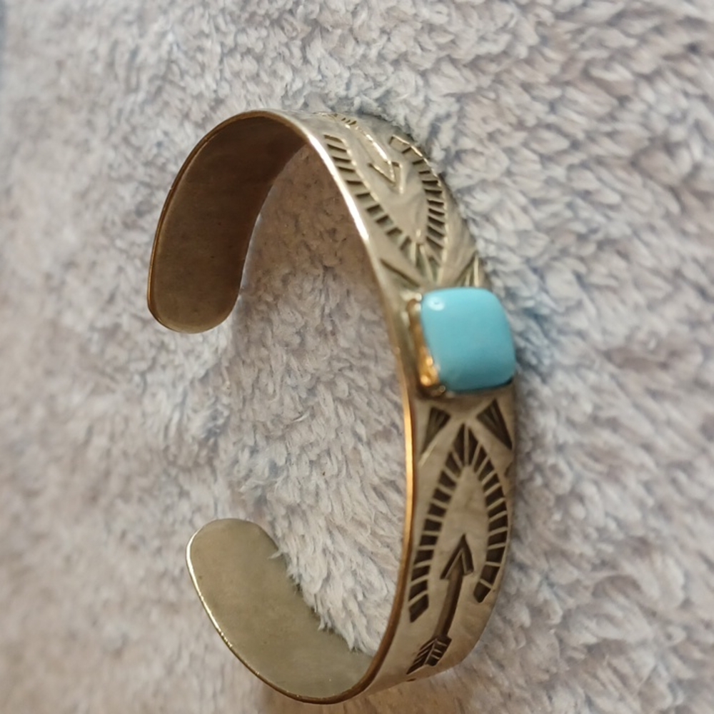 Stamped turquoise cuff.